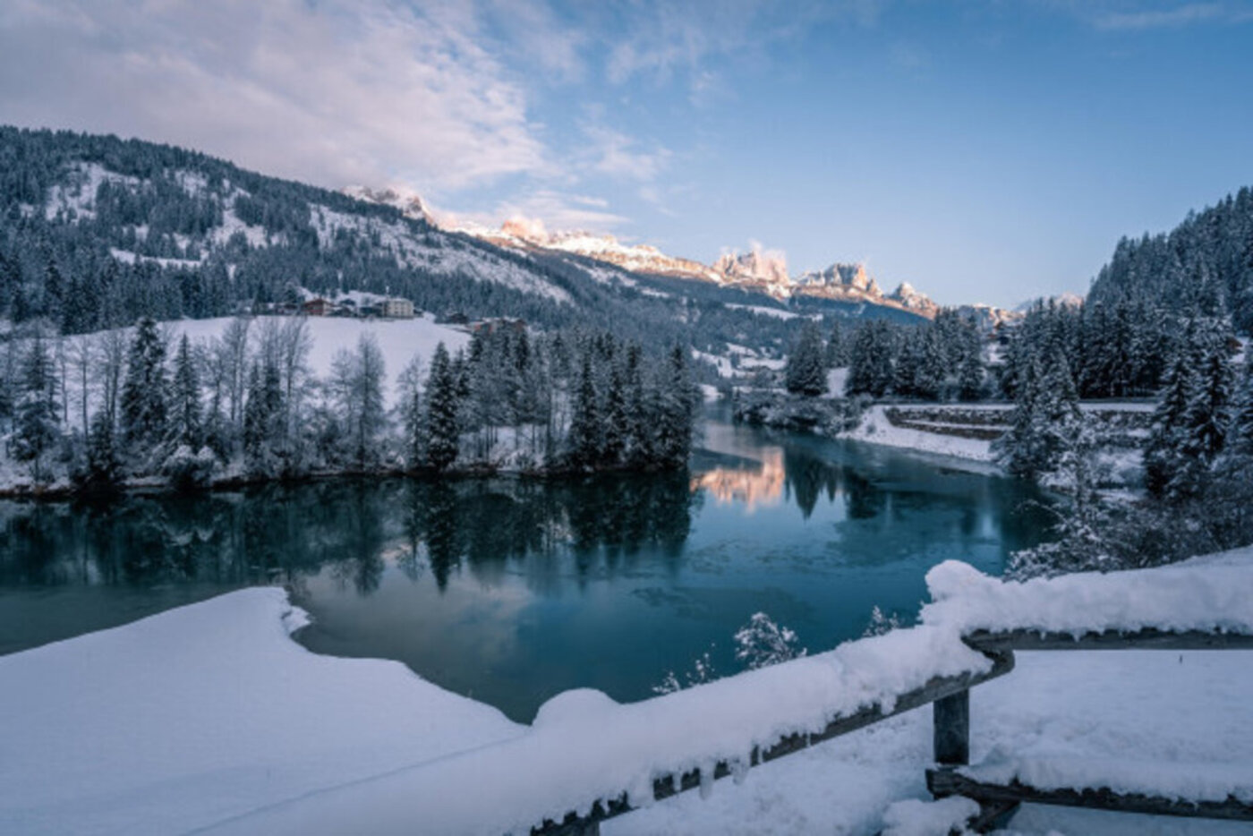 Lago di Soraga di Fassa in inverno al tramonto Dolomiti